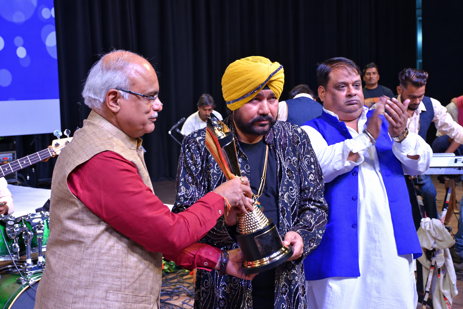 Artists and guests gathered on stage during an award presentation