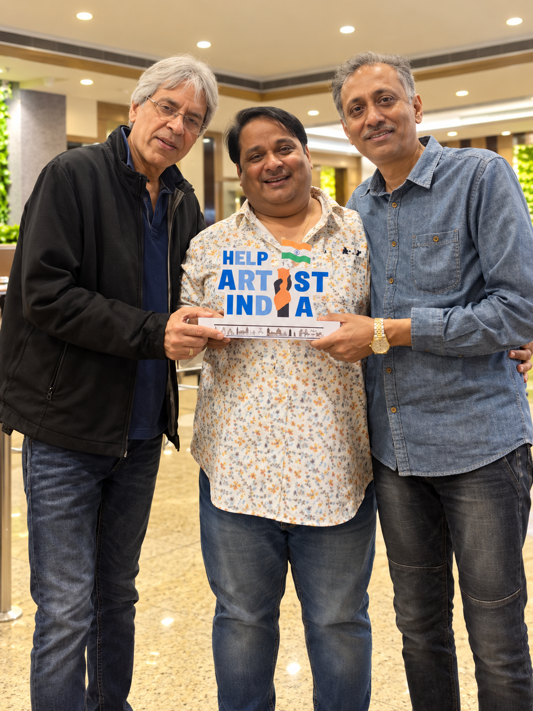 Foundation collaborators holding a Help Artist India sign